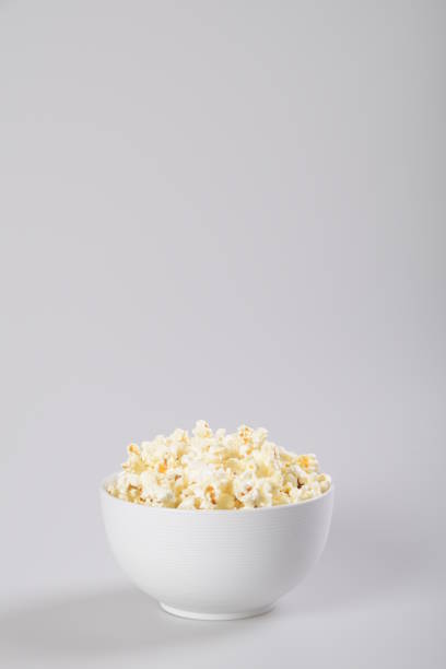 istock Popcorn in a bowl, isolated on white. 1153194458