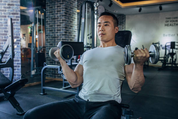 istock Asian bodybuilder building his muscles 1153195278