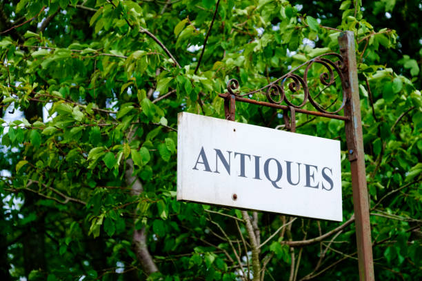 istock Antiques shop sign hanging on old iron post 1153195987