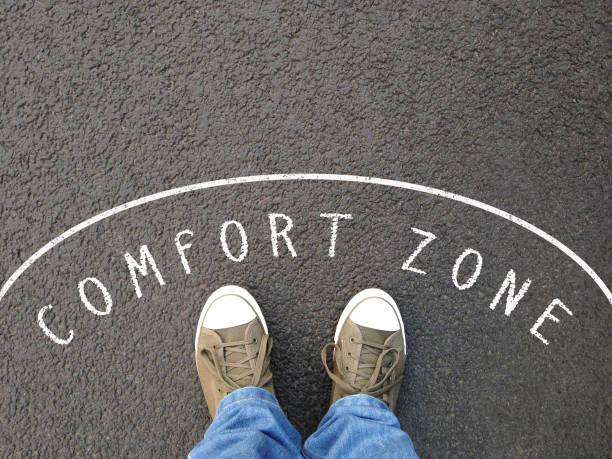 feet in canvas shoes standing inside comfort zone feet in canvas shoes standing inside comfort zone - foot selfie from personal perspective - chalk text on asphalt low section stock pictures, royalty-free photos & images