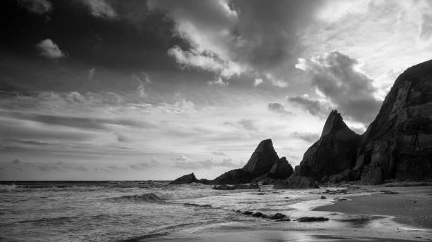 istock Stunning black adn white sunset landscape image of Westcombe Beach in Devon England 1153205402