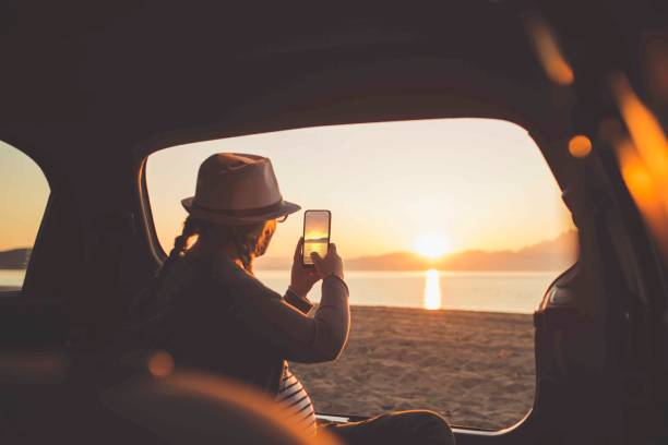istock Watching the sunset on the beach 1153207811