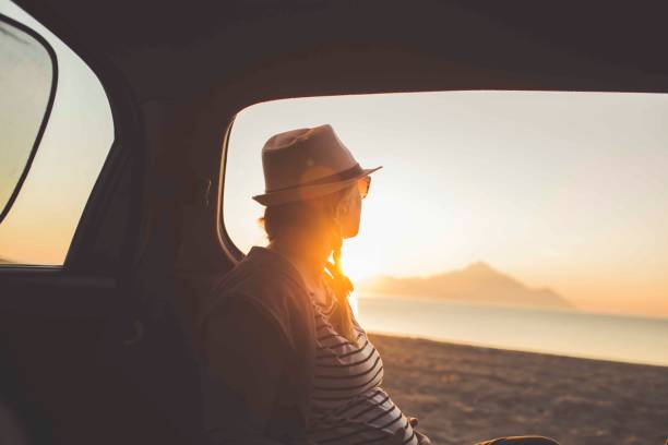 istock Watching the sunset on the beach 1153207919