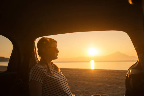 istock Watching the sunset on the beach 1153208109