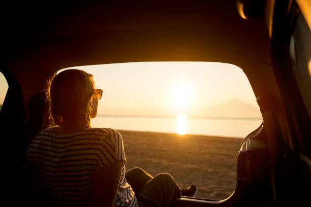 istock Watching the sunset on the beach 1153208272