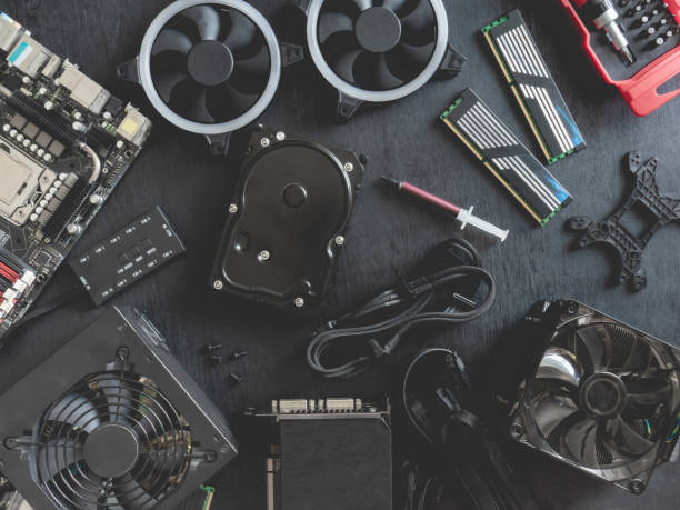 istock top view of computer parts with harddisk, ram, CPU, graphics card, and motherboard on black table background. 1153208300