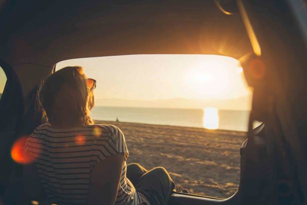 istock Watching the sunset on the beach 1153209054
