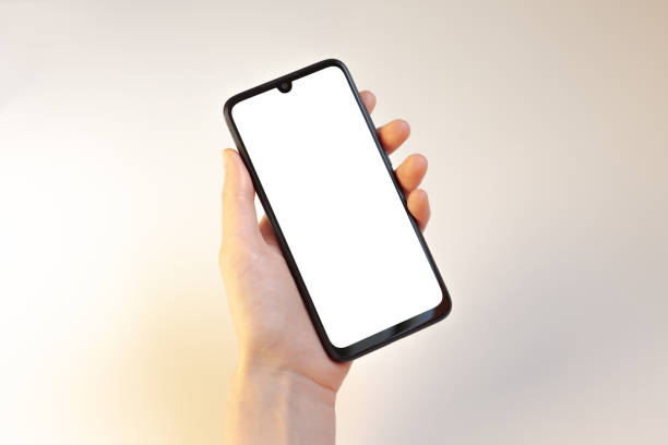 istock Female hands holding phone on white 1153209115