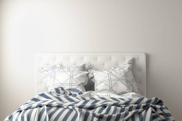 istock Bed with duvet, bedding and pillows isolated on white. 1153209154