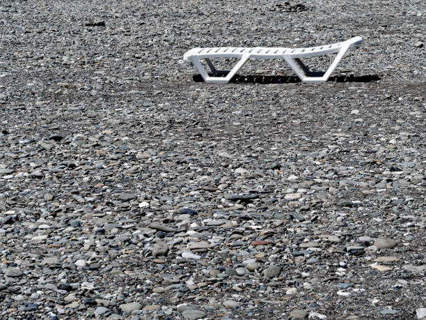 A chaise longue on the pebble beach