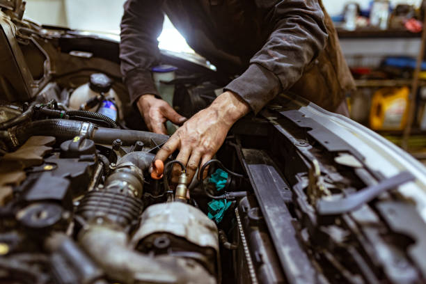 istock Auto mechanic working in garage. Repair service. 1153209551