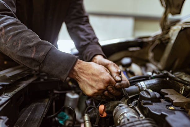 istock Auto mechanic working on a car engine in repair shop 1153209742