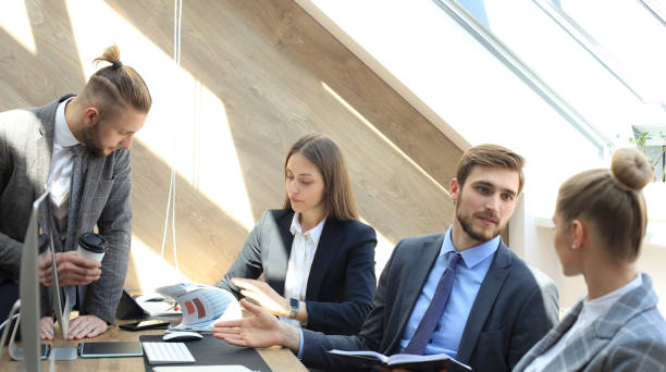 istock Business partners discussing documents and ideas at meeting. 1153209750