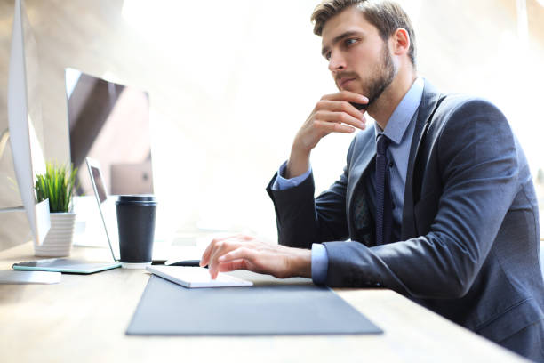 istock Modern businessman thinking about something while sitting in the office. 1153210476