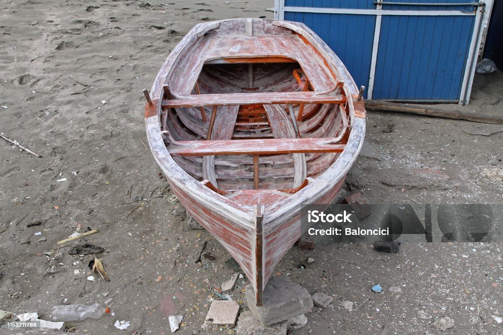 Dinghy Small Wooden Dinghy Boat Repair at Beach Nautical Vessel Stock Photo