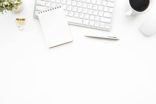 istock White minimal office desk table with computer keyboard, mouse and supplies. Top view with copy space, flat lay. 1153214134