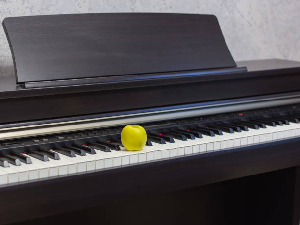 istock Apple on the classic electrical piano keyboard 1153214329