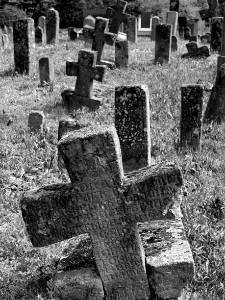 istock Old cemetery with stone crosses, black and white 1153215421