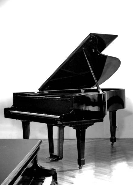 istock Black grand piano isolated on white wall 1153215426