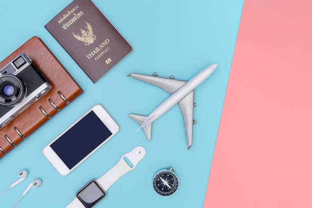 istock travel objects and accessories on blue pink background with passport camera and plane 1153216671