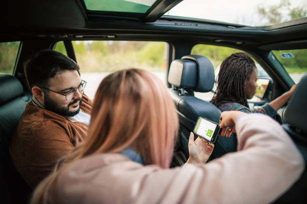 istock Friends using mobile app at the car 1153216692