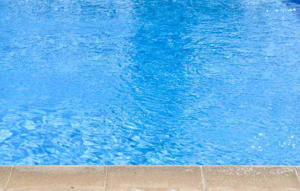 istock Close-up high angle view of blue  swimming pool at noon . 1153218683