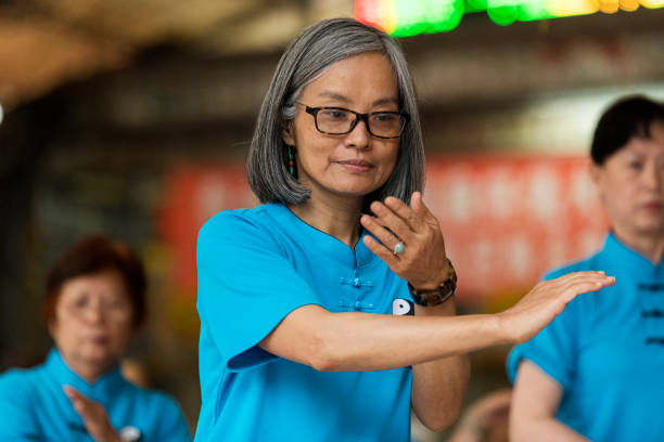 Peaceful senior woman doing Tai Chi