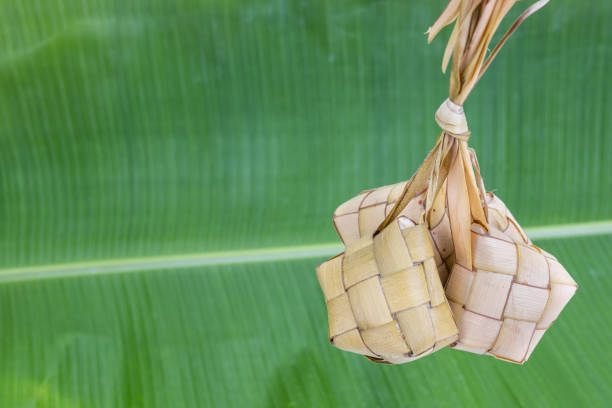 istock Bunch of ketupat hanging from its weaved palm leafs 1153218971