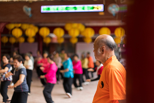 China, Beijing, June 5, 2011. A group mothers doing Tai Chi exercises for body health in the courtyard of Summer Palace complex.