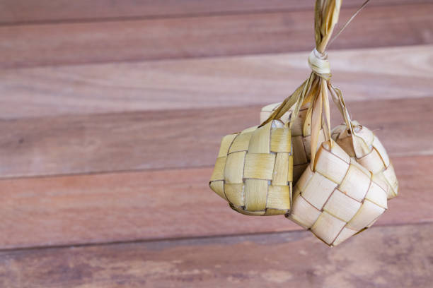 istock Bunch of ketupat hanging from its weaved palm leafs 1153218989