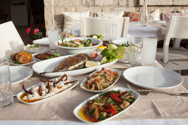 istock people drinking alcohol and eating foods at restaurant table 1153220922