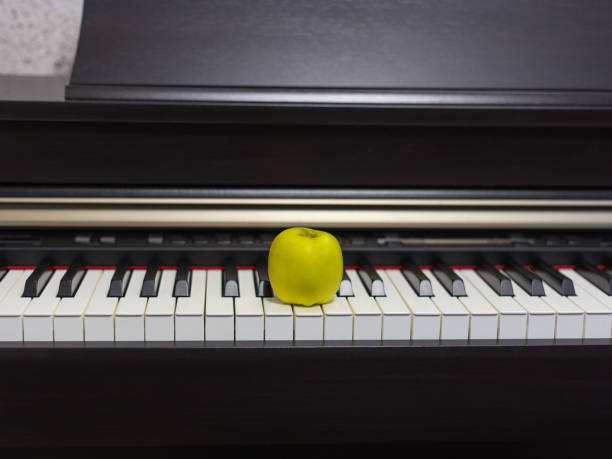 istock Apple on the classic electrical piano keyboard 1153221783