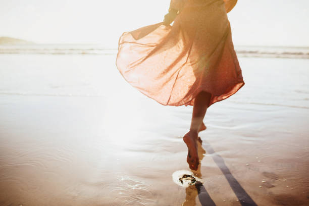 istock Young woman running on seaside path. 1153222771
