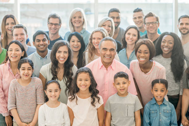 Large group of happy people standing together and looking at camera.