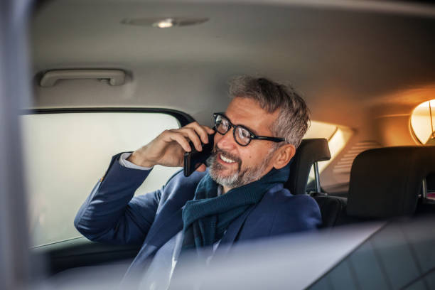 istock Businessman using mobile phone in car 1153224673
