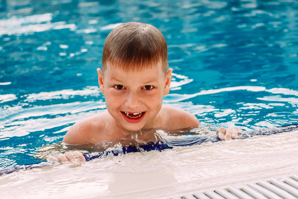 istock six-year-old boy in a blue pool 1153225354