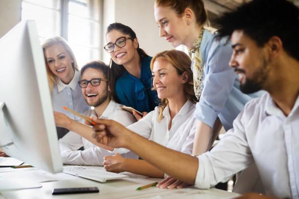 istock Successful happy group of people learning software engineering and business during presentation 1153226007