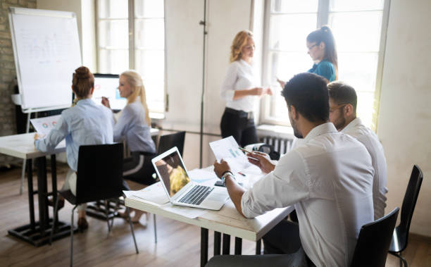 istock Successful happy group of people learning software engineering and business during presentation 1153226023