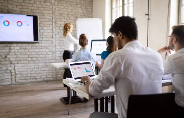 istock Successful happy group of people learning software engineering and business during presentation 1153226033