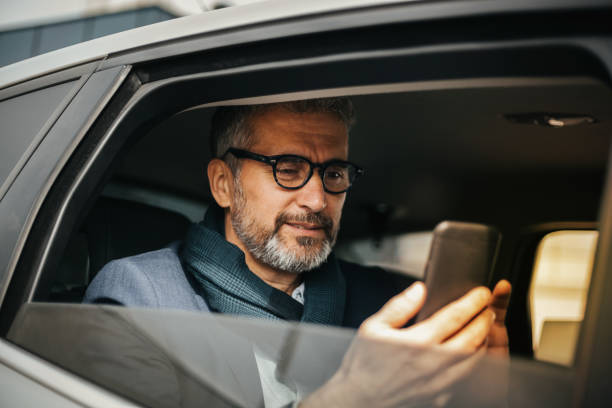 istock Businessman using mobile phone in car 1153226254