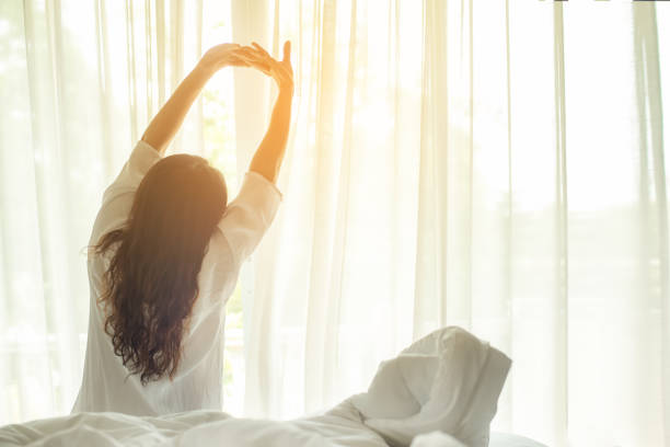 asian women waking up stretching in bed at home, morning and sunny day.  lifestyle concept - sensuality lifestyles cheerful comfortable imagens e fotografias de stock