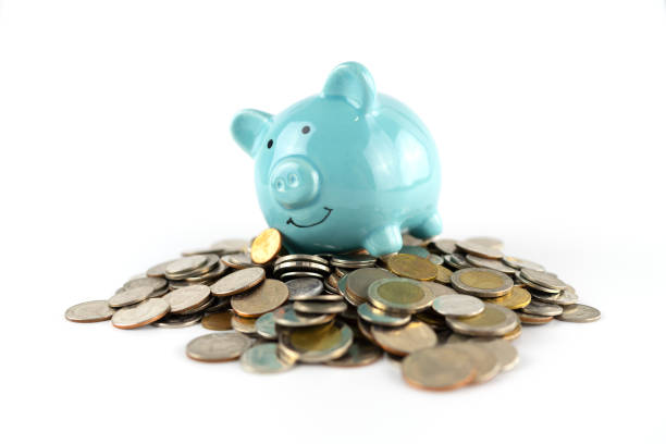 istock Blue piggy bank on many coins 1153227356