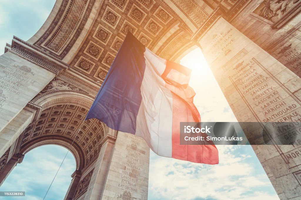 french flag at arc de triomphe on 14th of july french flag at arc de triomphe during bastille day France Stock Photo