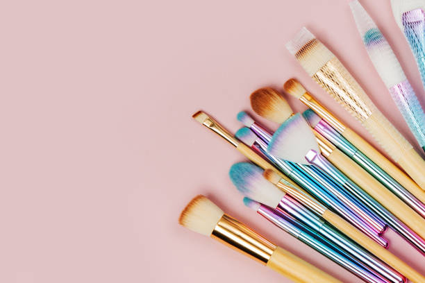 istock Various makeup brushes with Brush Cleansing Pad and brush guard on a pastel pink background. Flat lay, top view 1153228888
