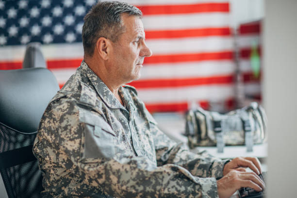 istock Senior man in  US military uniform working at the office 1153231009