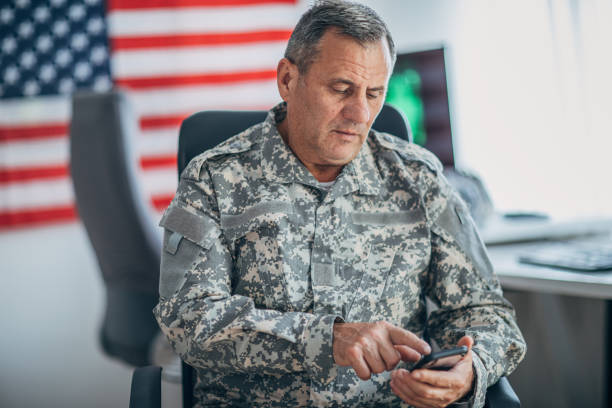 istock Senior soldier using smart phone at the office 1153231055