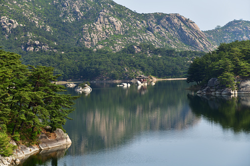 Amazing scenery of Samilpo lake. Wonderful reflections and smal island. It is one of North Korea designated Natural Monuments