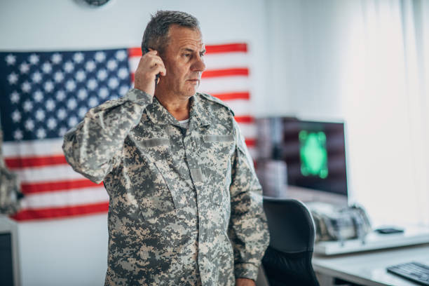 istock Serious senior soldier talking on smart phone 1153232210