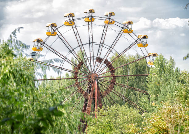 Abandoned ferris wheel in amusement park in Pripyat Abandoned ferris wheel in amusement park in Pripyat, Chernobyl area pripyat city stock pictures, royalty-free photos & images