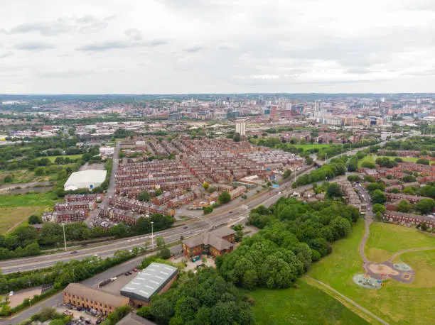 Aerial photo over looking the whole of Leeds from the Beeston area of the City Centre in West Yorkshire, the photo shows rows of 1940's terrace houses and playing fields.